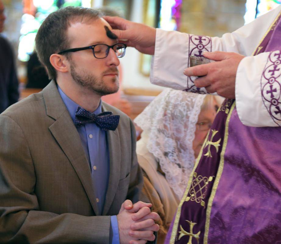 • Kip Arrowood receives ashes at Immaculate Conception Church in Forest City. (Photo by Giuliana Riley, correspondent)