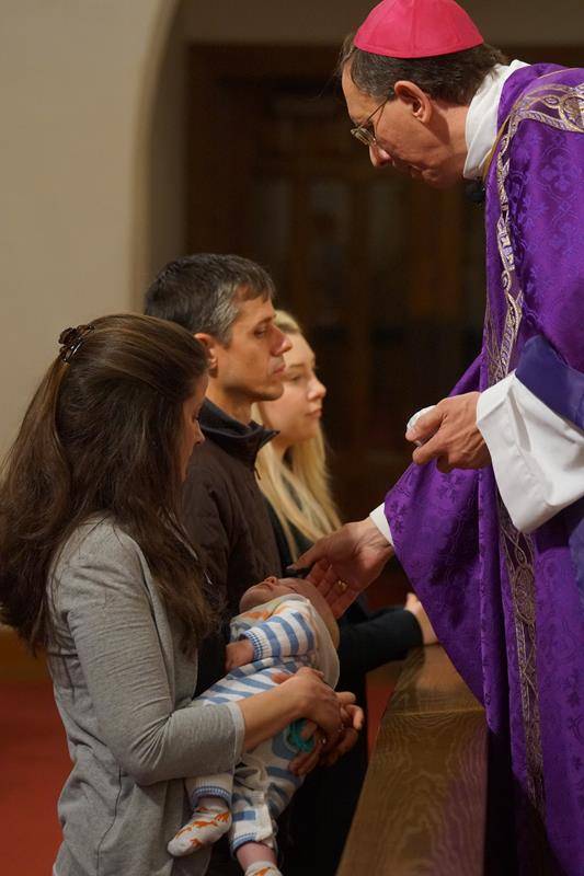 CHARLOTTE — Parishioners of St. Patrick Cathedral and students at St. Patrick School receive ashes from Bishop Peter Jugis during an 8:30 a.m. Mass on Ash Wednesday. (John Cosmas, Catholic News Herald)