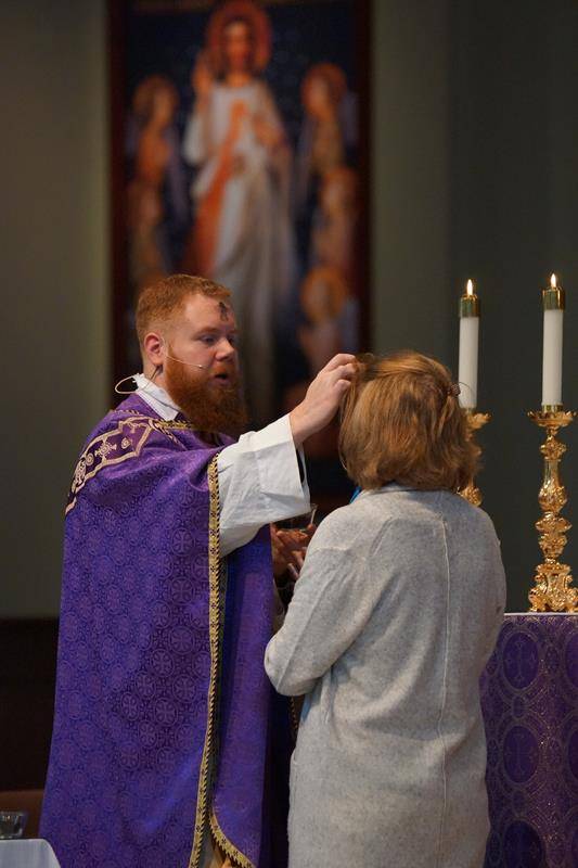 HUNTERSVILLE — St. Mark Church members receive ashes during a noon Mass at St. Mark Church.
