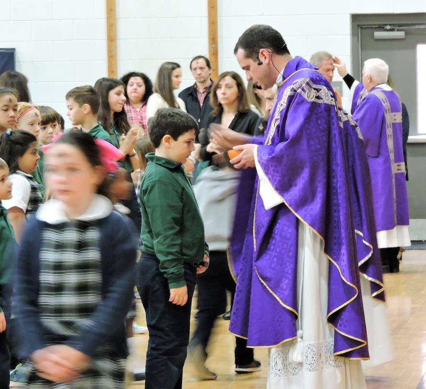St. Mark School students receive ashes during school Wednesday.