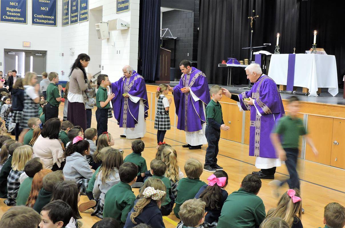 St. Mark School students receive ashes during school Wednesday.
