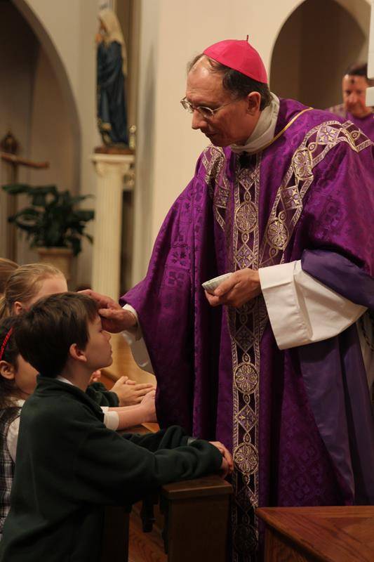 CHARLOTTE — Parishioners of St. Patrick Cathedral and students at St. Patrick School receive ashes from Bishop Peter Jugis during Mass on Ash Wednesday. (Patricia Guilfoyle, Catholic News Herald)