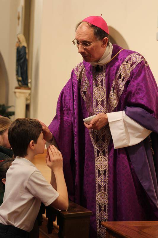 CHARLOTTE — Parishioners of St. Patrick Cathedral and students at St. Patrick School receive ashes from Bishop Peter Jugis during Mass on Ash Wednesday. (Patricia Guilfoyle, Catholic News Herald)