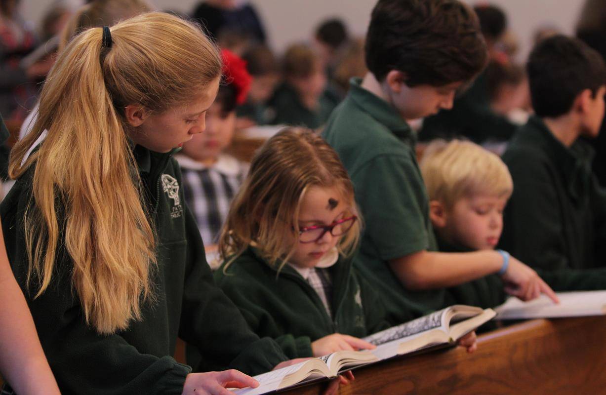 CHARLOTTE — Parishioners of St. Patrick Cathedral and students at St. Patrick School receive ashes from Bishop Peter Jugis during Mass on Ash Wednesday. (Patricia Guilfoyle, Catholic News Herald)