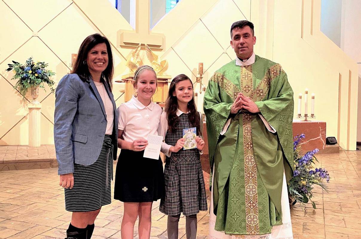 The beautiful work reflects the themes of “Learn, Serve, Lead, Succeed”. Pictured with the students are Principal Michele Snoke and Father Richard Sutter. (Provided by Darby McClatchy)