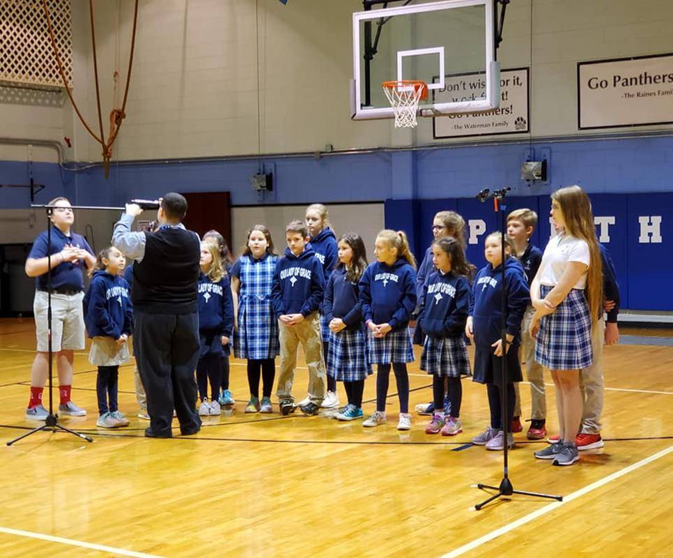 In honor of the men and women that serve our country and our community, the Our Lady of Grace School Singers Choir performed the National Anthem, and the OLG Social Skills Club hosted a breakfast reception for our guests. (Photos via Facebook)