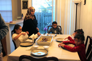 111215-refugees-Family-at-dinner-table