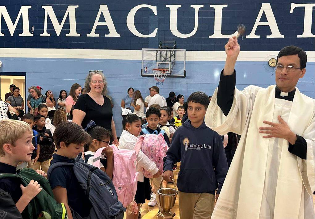 Father Daniel blessed the students’ backpacks.