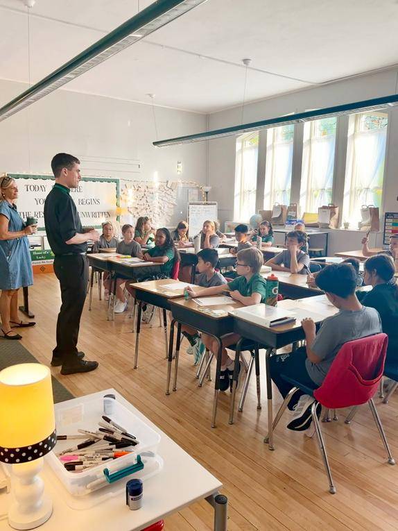 Father Peter visited classrooms.