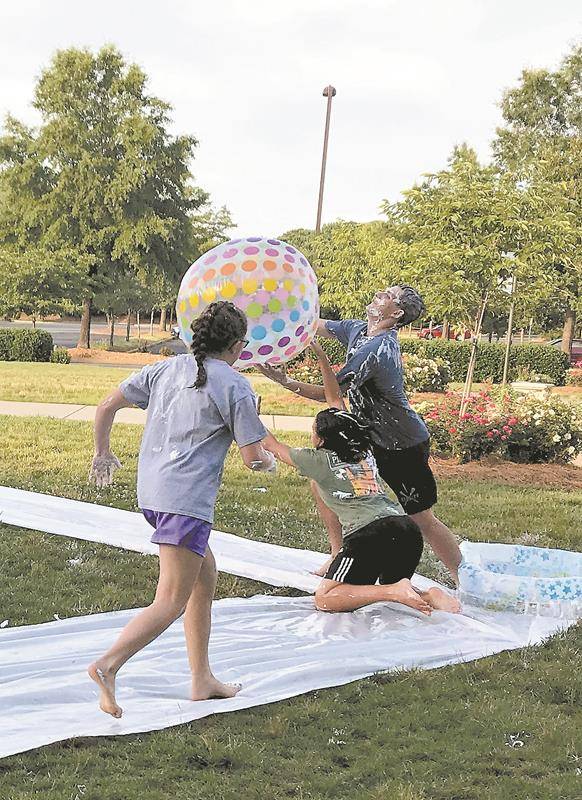 HUNTERSVILLE — (Above and left) Summer Life Teen and other summer youth programs are under way at St. Mark Church, where the high school ministry began the summer by inviting the new rising freshman class to a luau, shaving cream kickball and water slide
