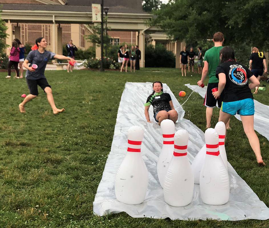 HUNTERSVILLE — (Above and left) Summer Life Teen and other summer youth programs are under way at St. Mark Church, where the high school ministry began the summer by inviting the new rising freshman class to a luau, shaving cream kickball and water slide