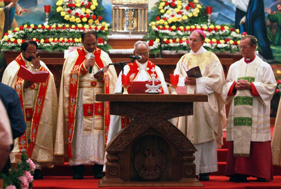 Bishop Jacob Angadiath prays during the start of Holy Qurbana, or Mass, before the little altar at St. Mary's Syro-Malabar Church.