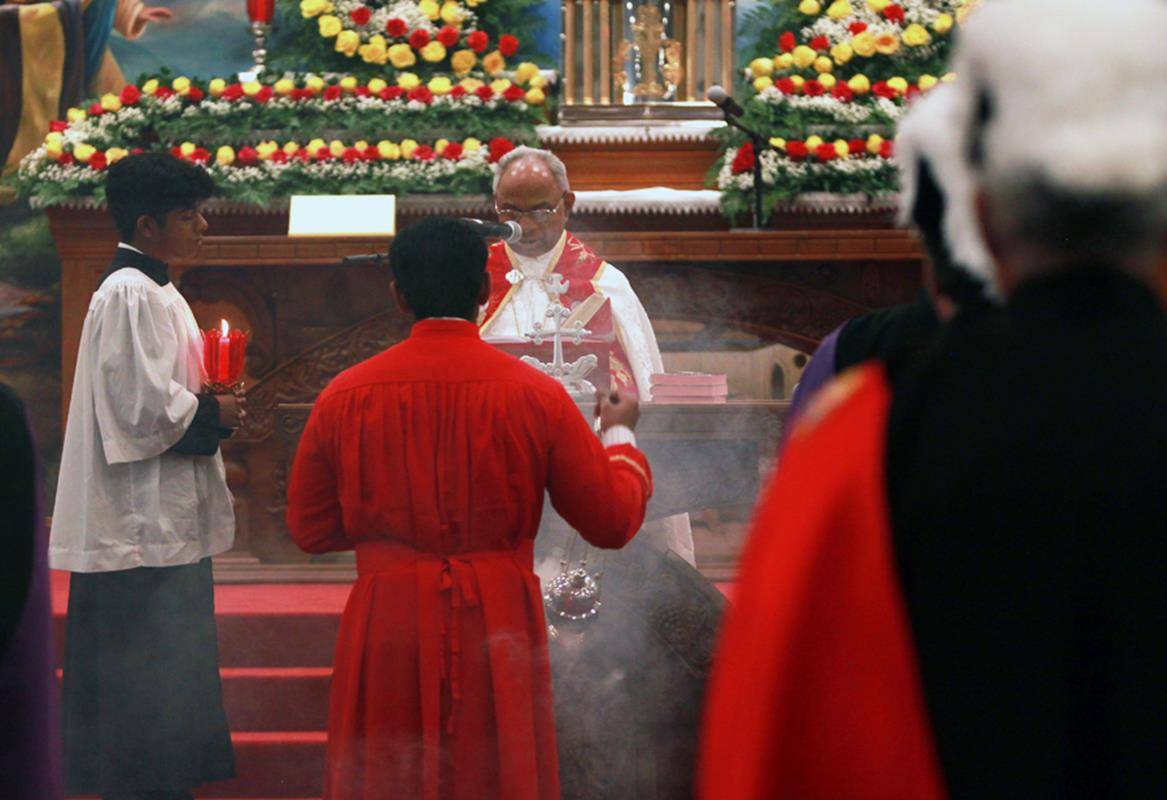 Bishop Jacob Angadiath proclaims the Gospel reading during the Mass.