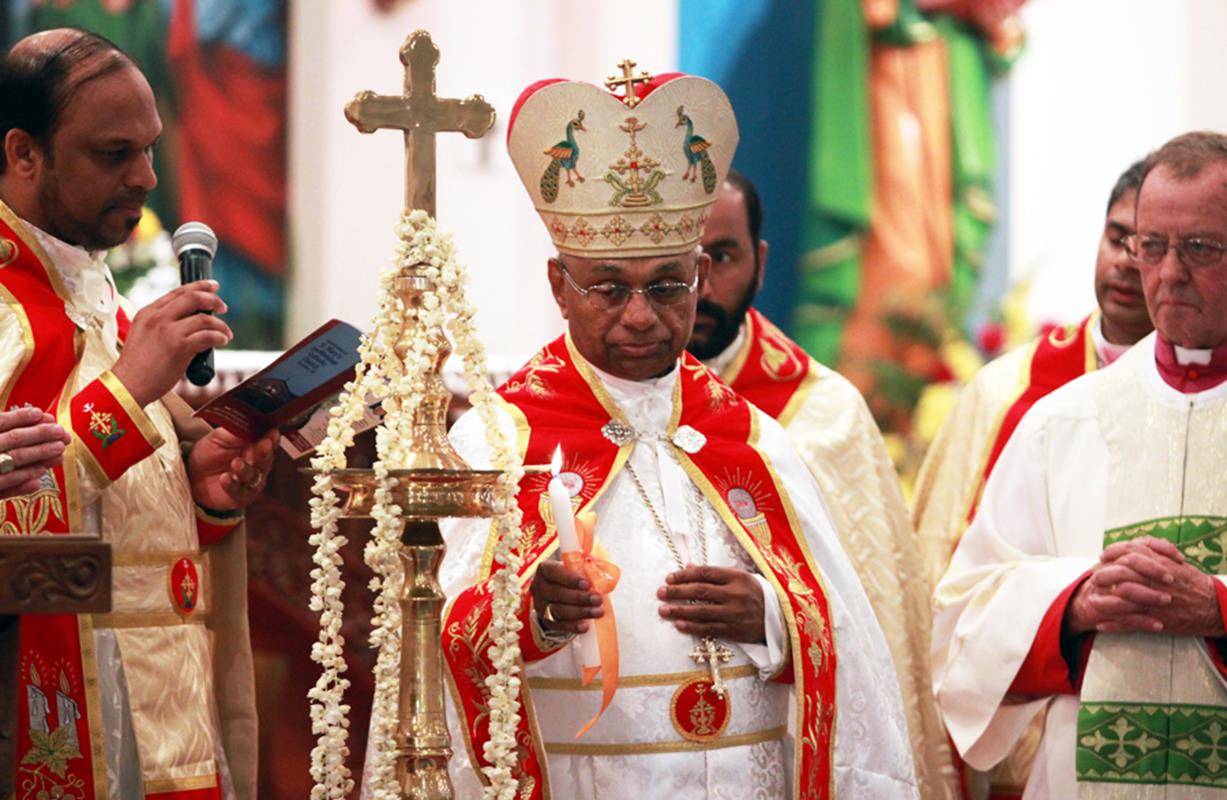 Bishop Jacob Angadiath lights the Paschal candle during the consecration of St. Mary’s Church.