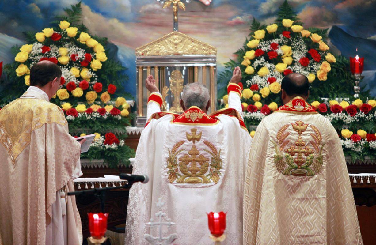Bishop Jacob Angadiath prays the Eucharistic Prayer during Mass, or Holy Qurbana, at St. Mary’s Syro-Malabar Church in Charlotte. Also pictured are Bishop Peter Jugis and Father Johnykutty Pulissery, eparchial chancellor.
