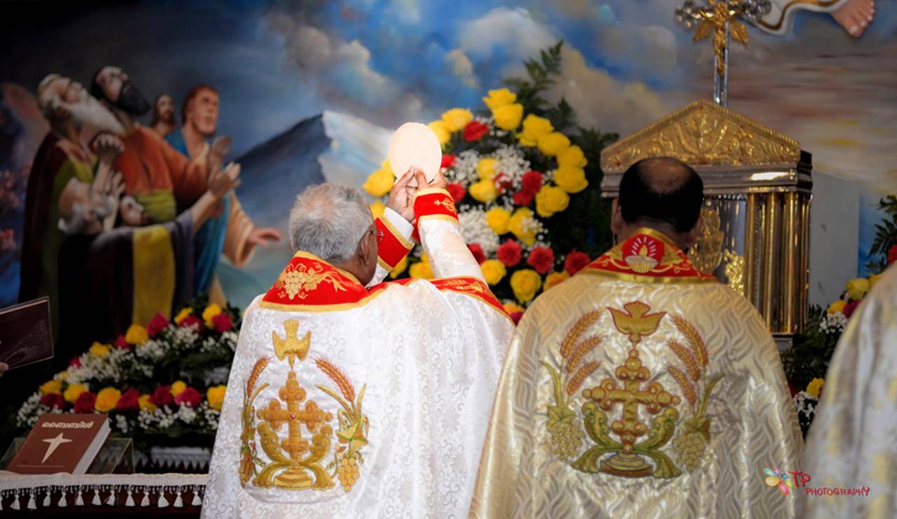 Bishop Jacob Angadiath elevates the consecrated Host during the first Mass at St. Mary's Syro-Malabar Church.