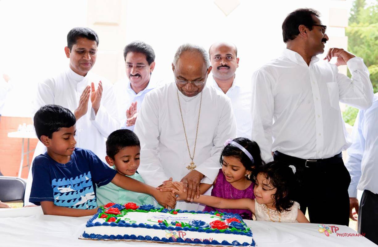 Bishop JaParishioners celebrated the church’s consecration with traditional Indianhurch’s consecration with traditional Indian music and food after Mass. music and food after Mass.cob Angadiath gets help from children of the parish in cutting the cake dur
