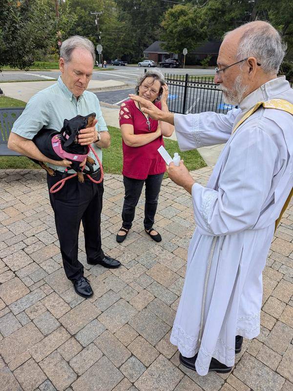 Deacon Ralp blesses happy animals at St. Leo the Great Church in Winston-Salem. 