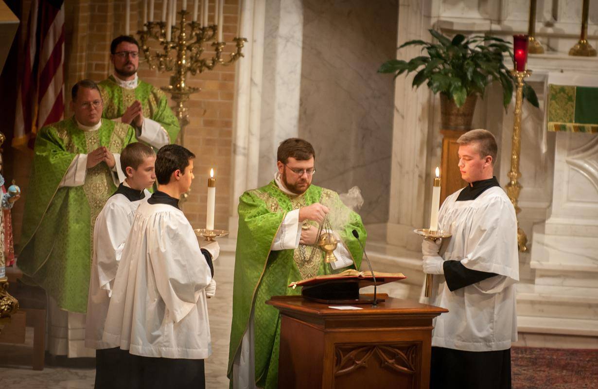 Father Buchanan incenses the Gospel before proclaiming the Gospel reading at his installation Mass Sept. 2 (Photos by Jarek Lucek)