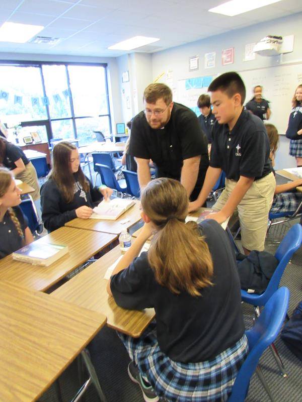 Father Buchanan speaks with OLG's seventh-grade religion class. (Photo by Annie Ferguson)