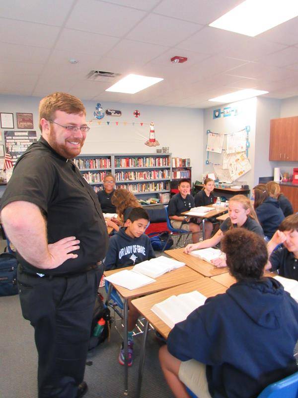 Father Buchanan visits with OLG's seventh-grade religion class. (Photo by Annie Ferguson)
