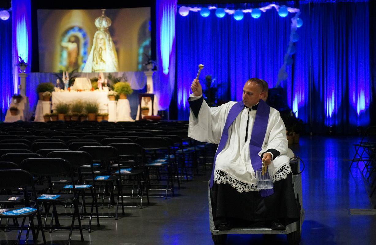 Father Matthew Buettner, pastor of St. Michael Church in Gastonia, blesses the Charlotte Convention Center Sept. 8 before the start of the 13th annual Eucharistic Congress. #goeucharist (Photo by John Cosmas, correspondent)