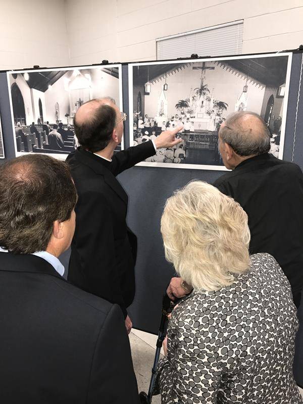 _Bishop Jugis and Monsignor Showfety look at archival photos of St. Benedict (Copy)