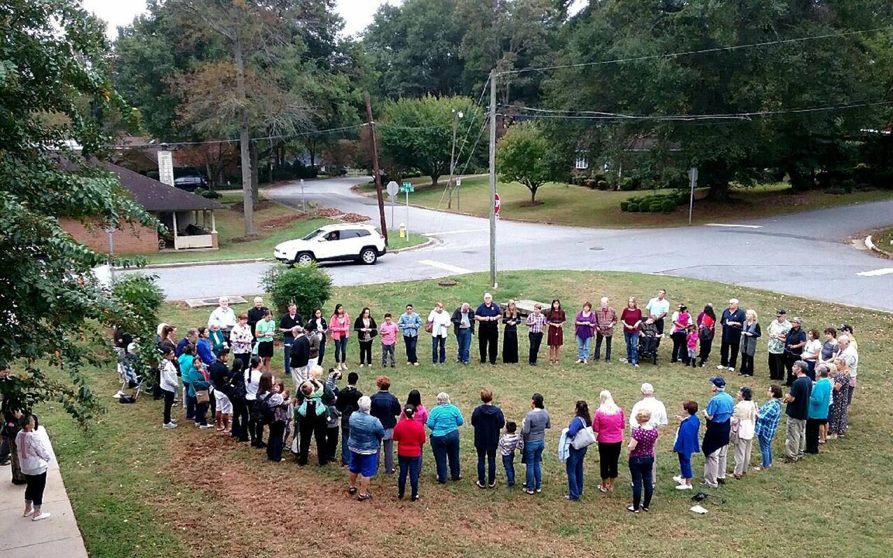 Parishioners of St. Aloysius Church in Hickory, with Father Larry LoMonaco, pastor, held a 150-foot rosary to form a “living bilingual rosary” Oct. 14 to commemorate the Fatima anniversary, despite the rain – which they called “tears of joy” as a blessing