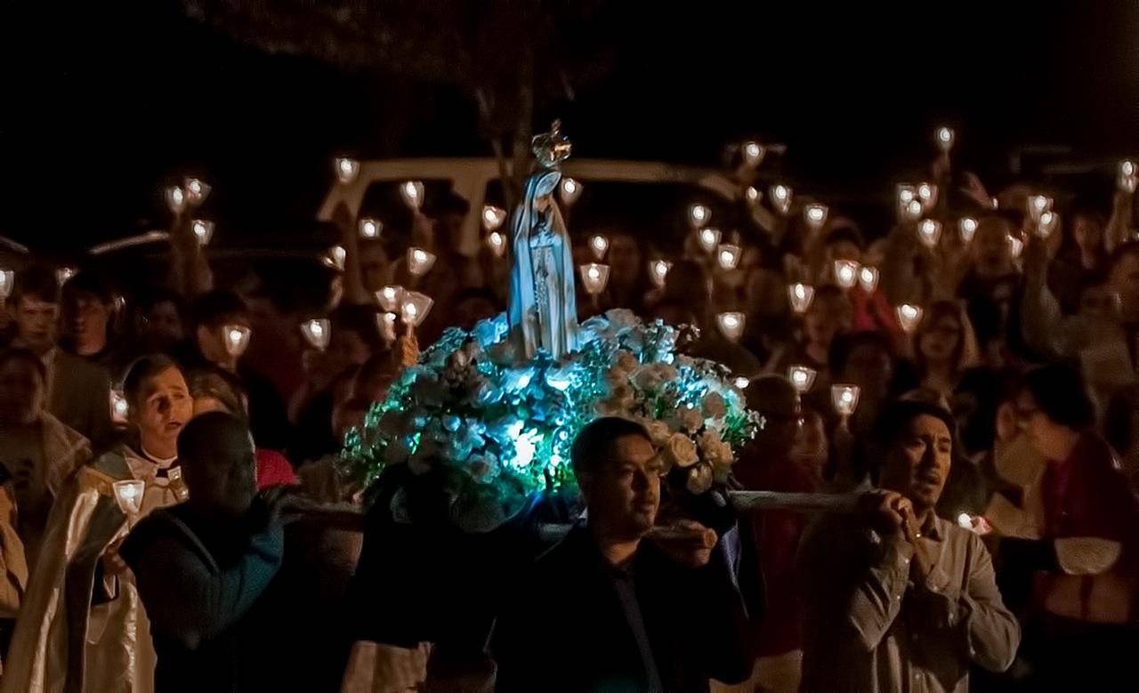 Father John Eckert, pastor, and Deacon Jim Mazur lead parishioners in a candlelight Marian procession on the grounds of Sacred Heart Church in Salisbury Oct. 13. Photo by Bill Washington, Catholic News Herald