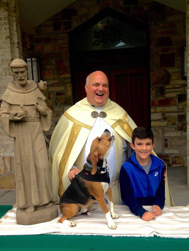 Pictured with Monsignor Anthony Marcaccio, pastor, outside St. Pius X Church in Greensboro is Brendan Queen with his dog Stewie. (Photo provided by Liz Pendergrass)
