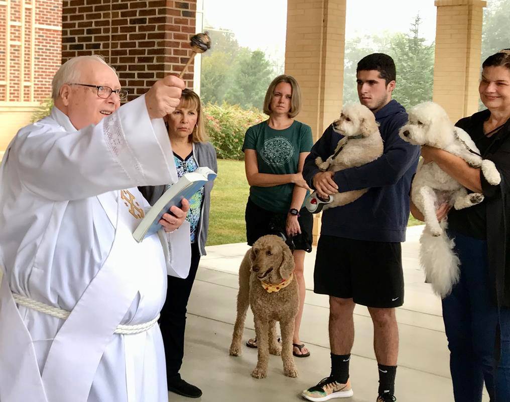 Deacon Ron Sherwood blessed parishioners and their pets at St. Mark Church in Huntersville Oct. 7. Deacon Sherwood began – over the sound of yelps, barks and chirps – by saying, “We are blessed to have all of these beautiful animals with us today,” and th