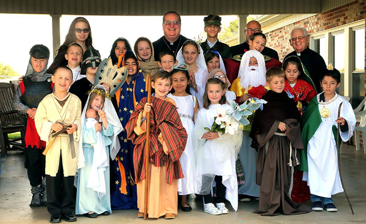 All of the children with Father Herbert Burke, pastor, and Deacons Sigfrido Della Valle and Andy Cilone.