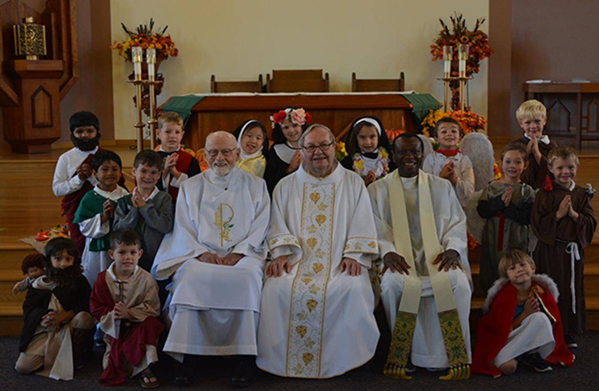 Pictured with the kinder class are (from left) Deacon Joe Schumacher, Father Joe Angelini, and visiting priest from Nigeria, Father Sylvanus P. Idiong.
