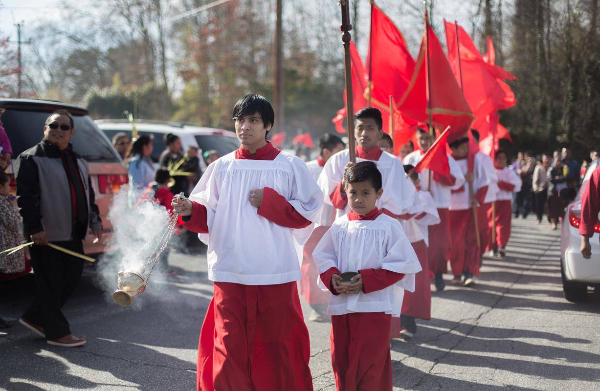 MORGANTON — Members of St. Charles Borromeo Church take part in a Palm Sunday procession March 25. (Photos by Lorenzo Pedro, correspondent)