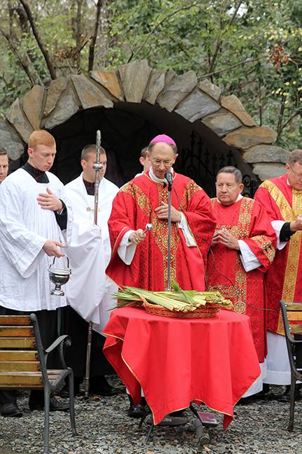 CHARLOTTE — Bishop Peter Jugis blesses palms at the start of Palm Sunday Mass March 25 at St. Patrick Cathedral. (Patricia L. Guilfoyle, Catholic News Herald)