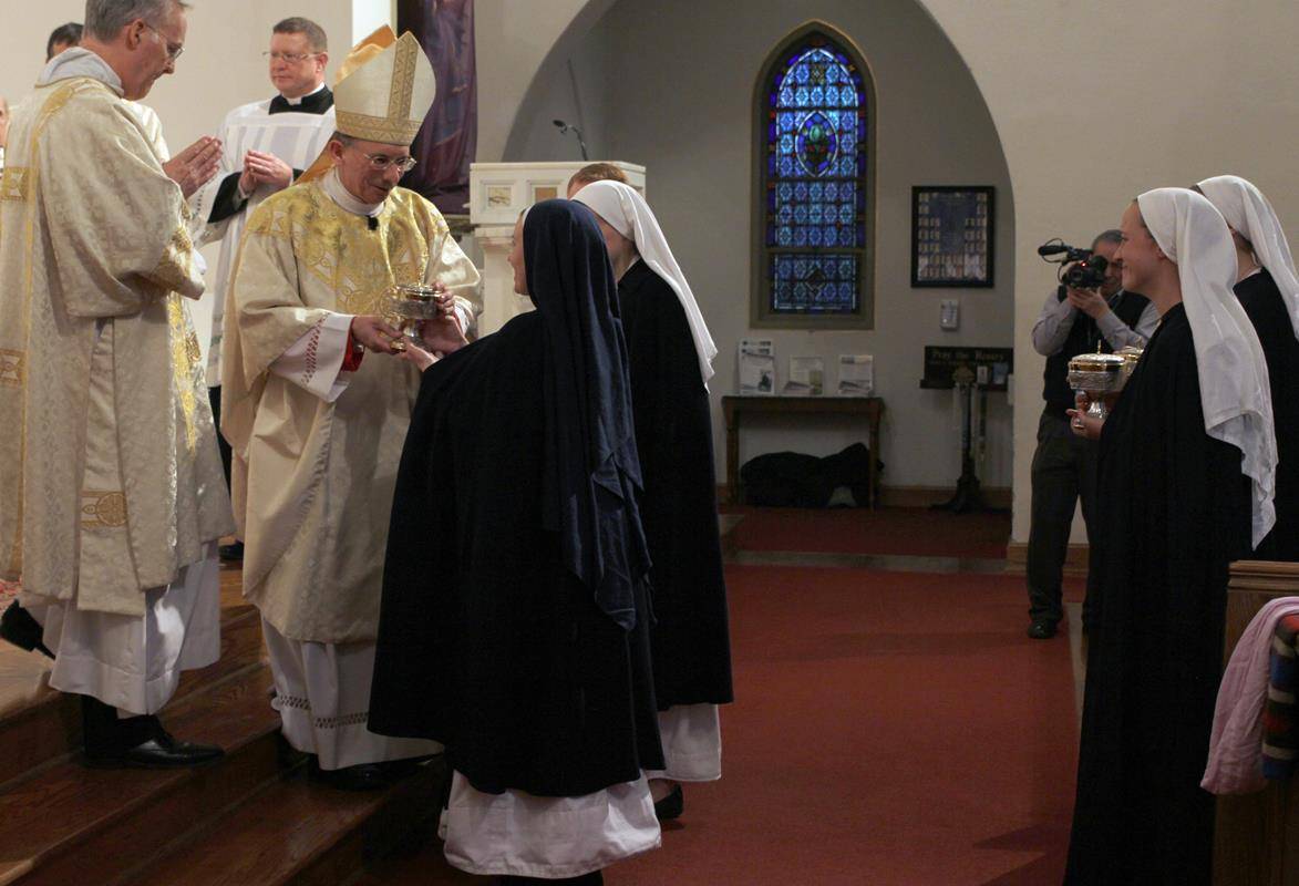 The offertory gifts are presented to Bishop Jugis by the Daughters of the Virgin Mother.