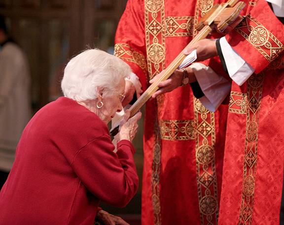 Parishioners at St. Patrick Cathedral venerate the cross. (Photo by SueAnn Howell, Catholic News Herald)