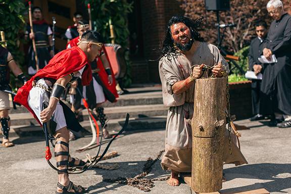 Jesus is flogged during the Via Crucis at St. Charles Borromeo Church in Morganton (Photo by Lorenzo Pedro, correspondent)