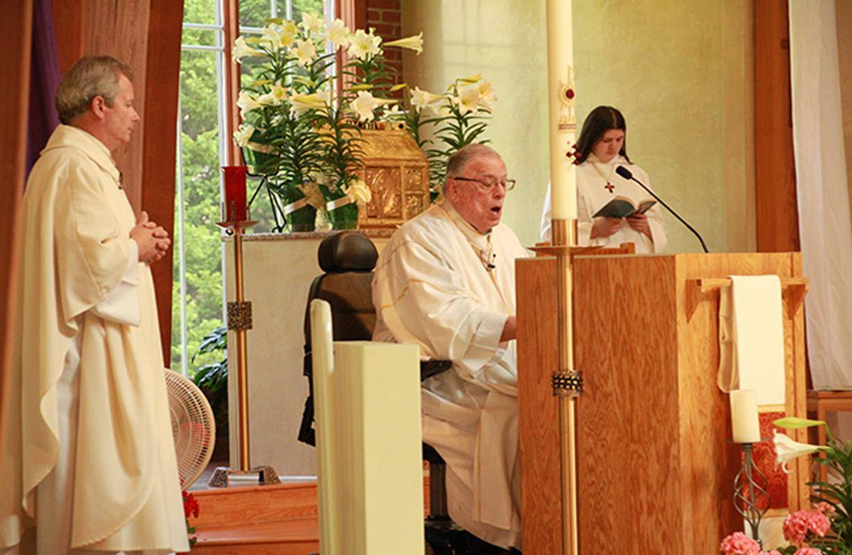 Fr. Paul DeChant, OSFS, celebrates Easter Mass at Holy Cross Church in Kernersville with Deacon Tim Ritchey assisting. (Photo by John Bunyea, correspondent)