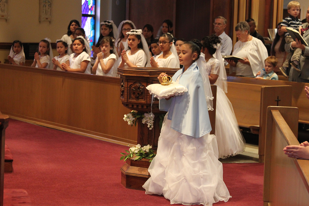 LINCOLNTON — Children receiving their first Holy Communion at St. Dorothy Church took part in a May Crowning after Mass May 5, led by Father David Miller, pastor. Bearing the crown was Maria Fernanda Alfaro Vazquez.