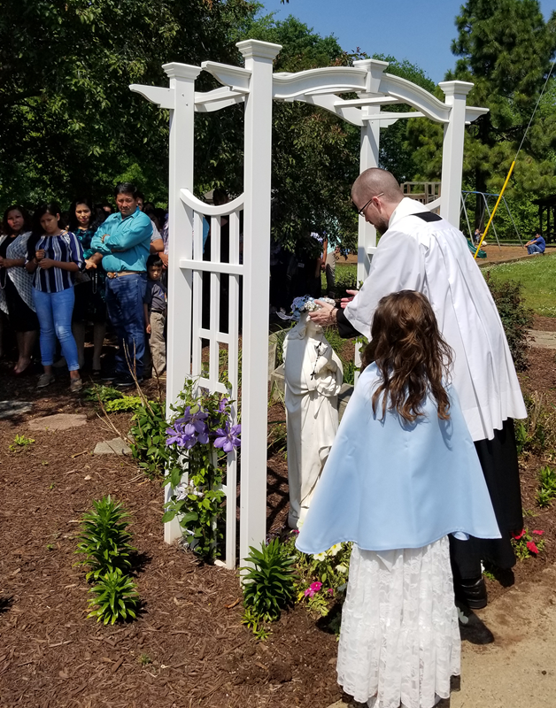 LINCOLNTON — Children receiving their first Holy Communion at St. Dorothy Church took part in a May Crowning after Mass May 5, led by Father David Miller, pastor. Bearing the crown was Maria Fernanda Alfaro Vazquez.