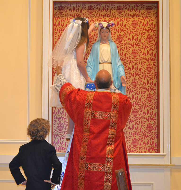 Second-graders at St. Ann School celebrated their first Holy Communion and crowned a statue of Mary during a recent Mass at St. Ann Church. (Photo provided by Kathy McKinney)