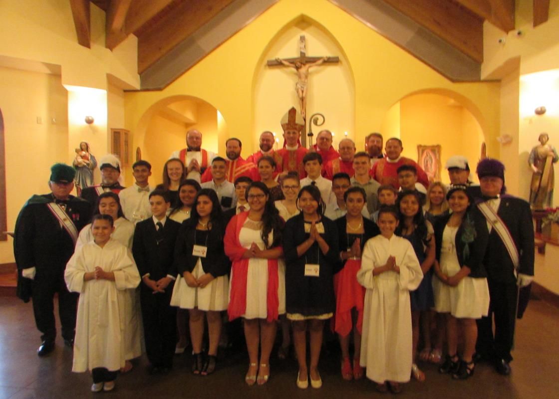 Youths at St. John the Evangelist Church in Waynesville received the sacrament of confirmation from Bishop Peter Jugis June 23