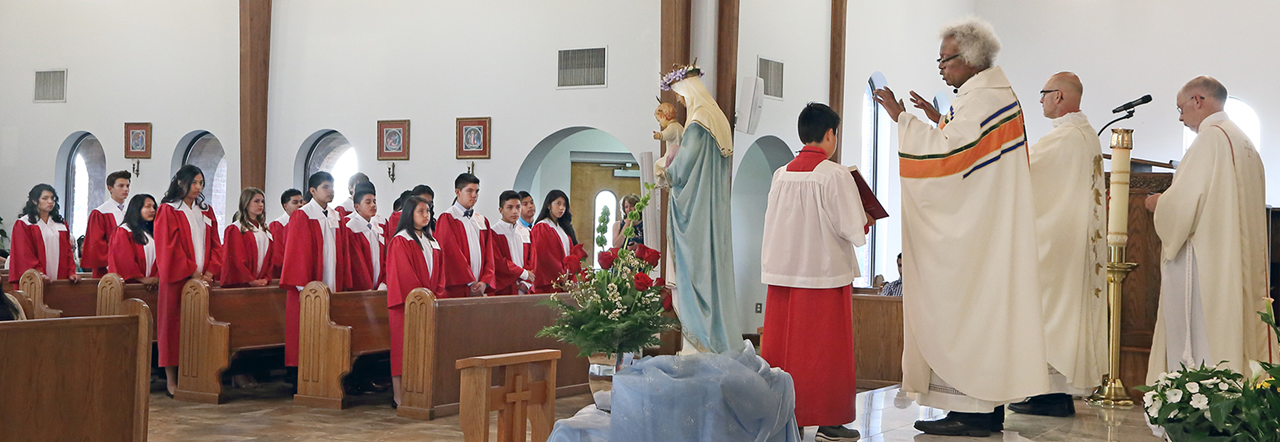 SHELBY — Twenty-three young people received the sacrament of confirmation from Monsignor Mauricio West, vicar general and chancellor of the Diocese of Charlotte, at St. Mary, Help of Christians Church May 13. (Giuliana Polinari Riley)