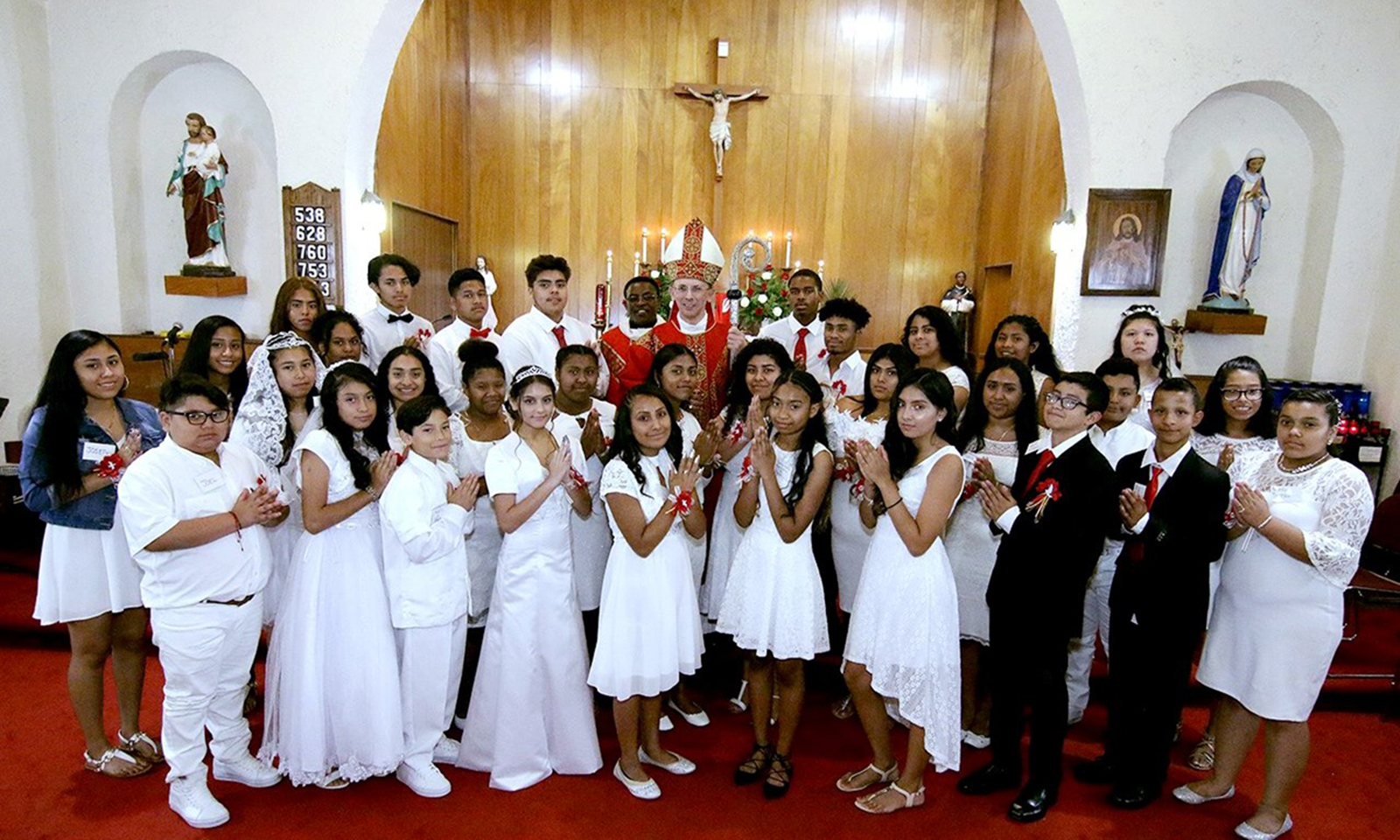 WINSTON-SALEM — Bishop Peter Jugis confirmed 32 young people during a July 23 Mass at St. Benedict the Moor Church. (Photo provided by Gloria Wilson)