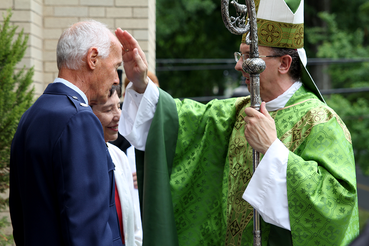 Retired Lt. Col. Bill Fountain and his wife Rosie receive a blessing after Mass from Bishop Jugis. The Fountains recently celebrated their 50th wedding anniversary.
