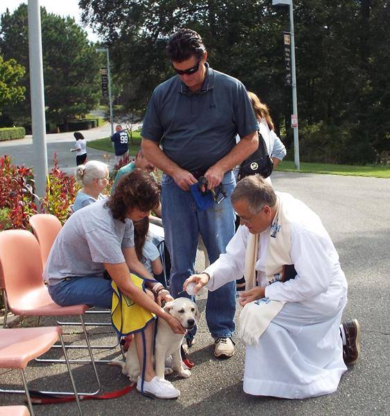 MINT HILL — Father Paul Gary blessed pets outside St. Luke Church in honor of the feast of St. Francis of Assisi. Father Gary, who grew up with dogs, has a Boston Terrier named Lucita de Dios. “I cannot imagine life without a dog,” he says. (Lisa Geraci)
