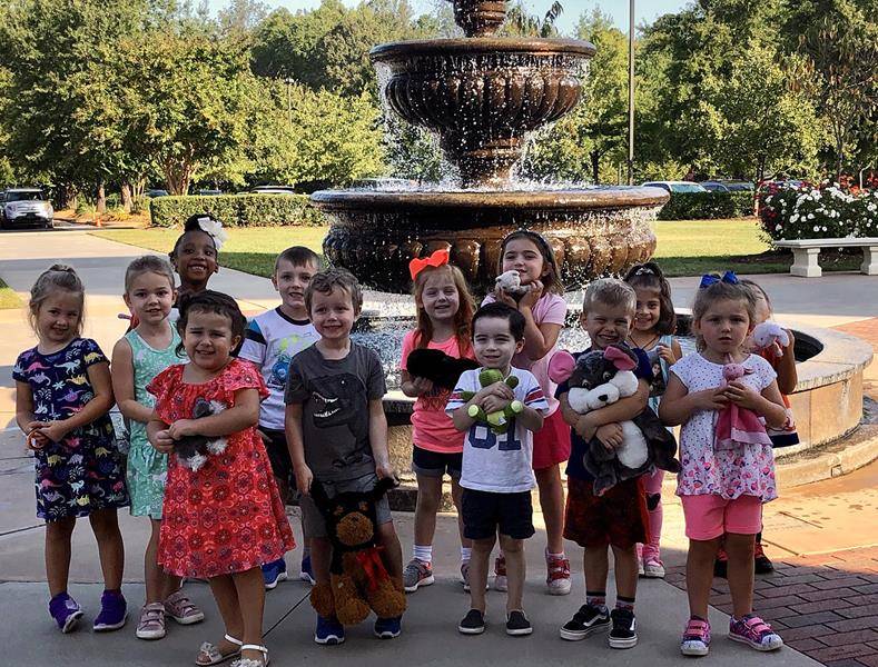 HUNTERSVILLE — Father Noah Carter, parochial vicar at St. Mark Parish, blessed St. Mark School pre-schoolers’ “animals” last week in honor of the feast of St. Francis of Assisi. (Photo from Facebook)