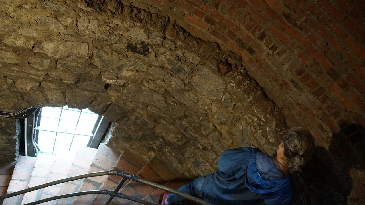 Technicians survey the stairway leading to the basement and the stairs leading to the bell towers.