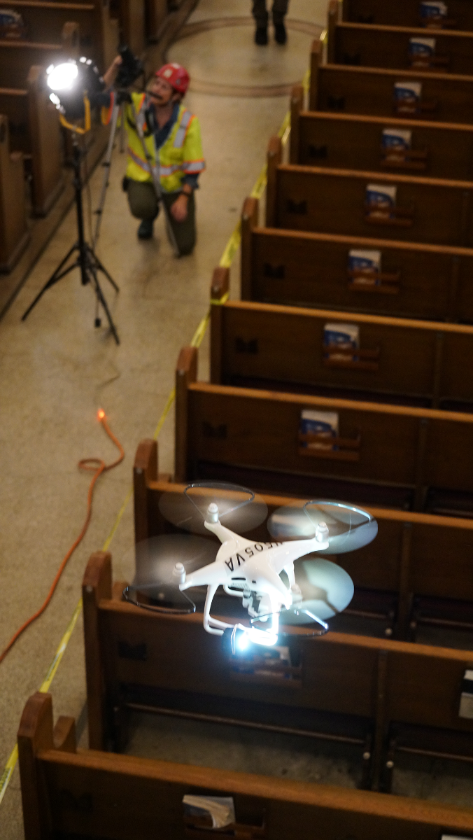 A drone flies high above the pews inside St. Lawrence Basilica.